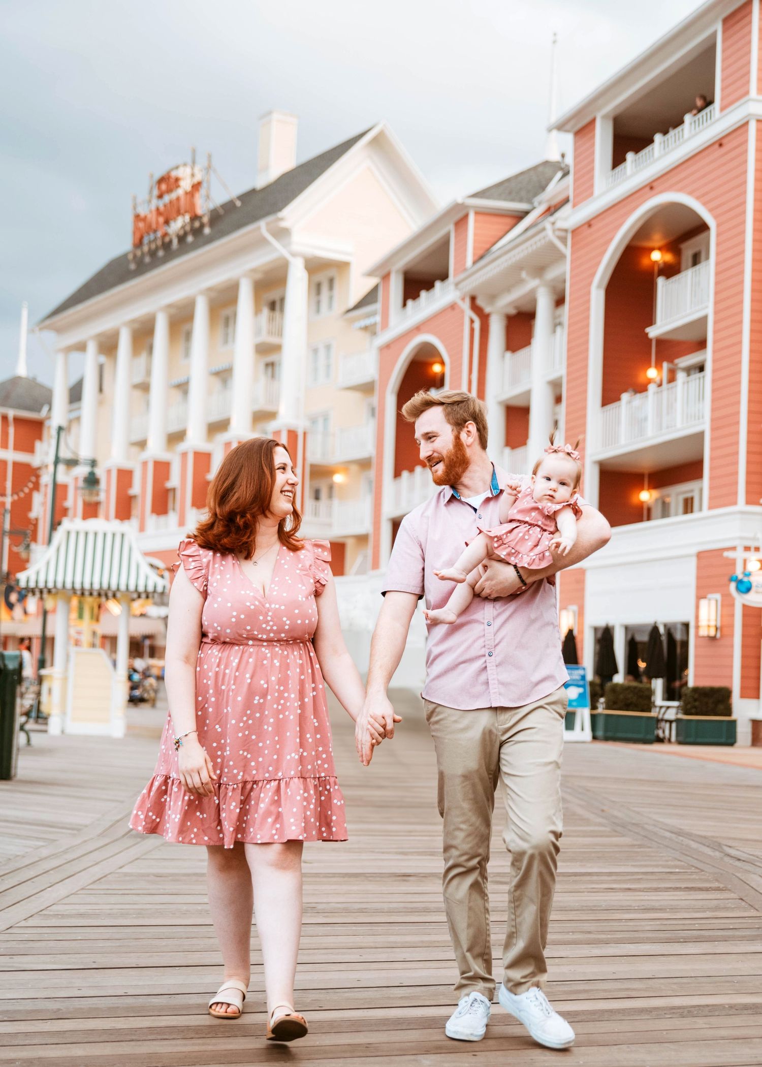 John & Emily anniversary photos at Disney Boardwalk with baby Ripley, taking a stroll on the boardwalk. Cred: LexTakePix
