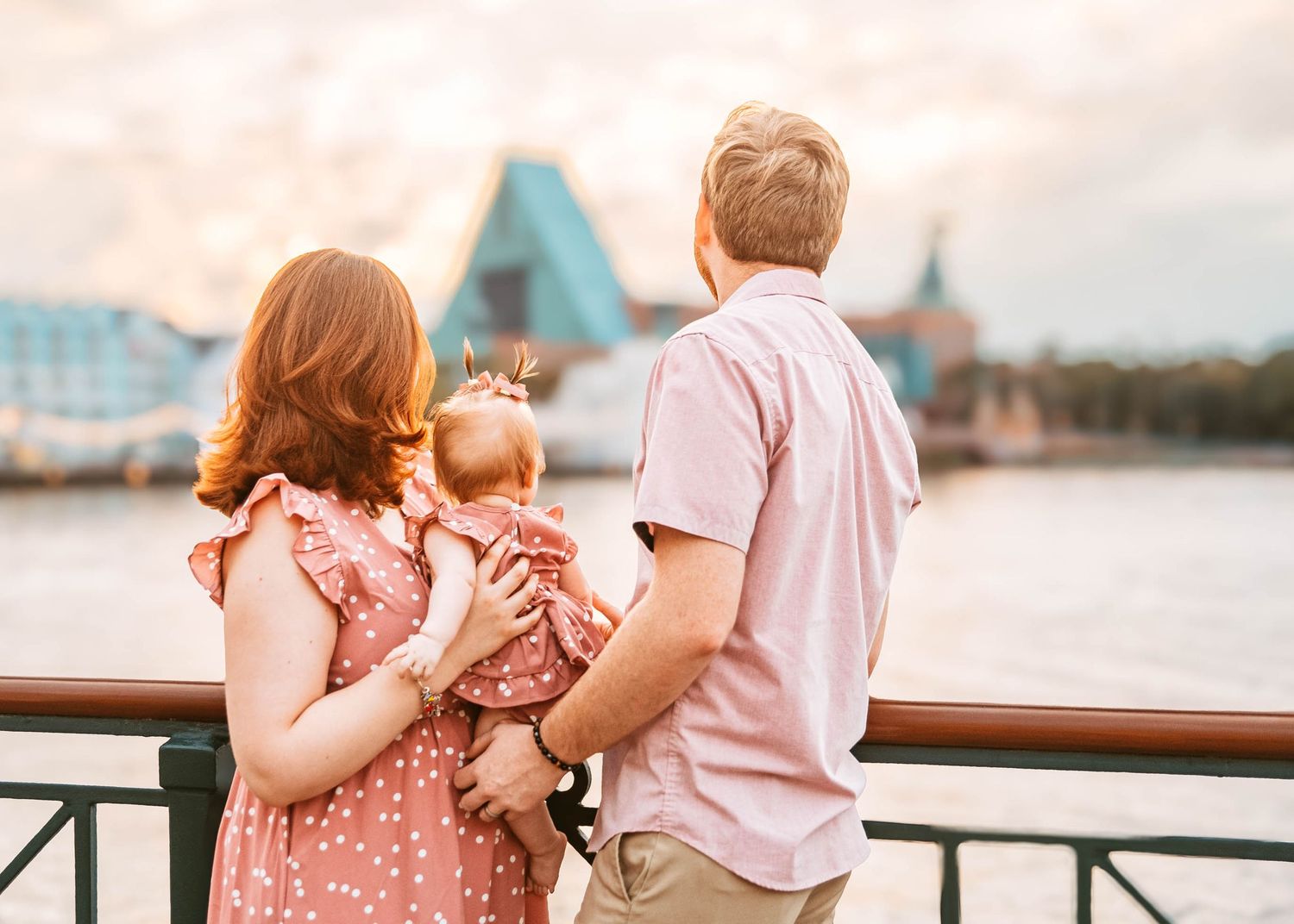John & Emily anniversary photos at Disney Boardwalk with baby Ripley, staring into sunset. Cred: LexTakePix