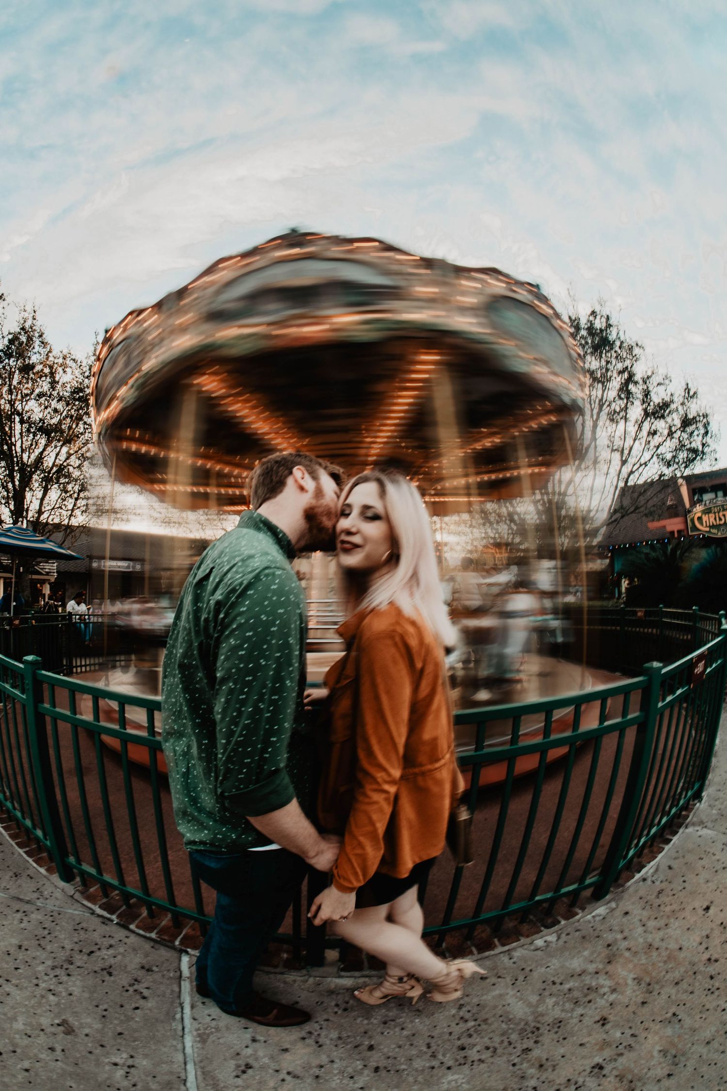 John & Emily anniversary photos at Disney Springs, in front of carousel. Cred: LexTakePix