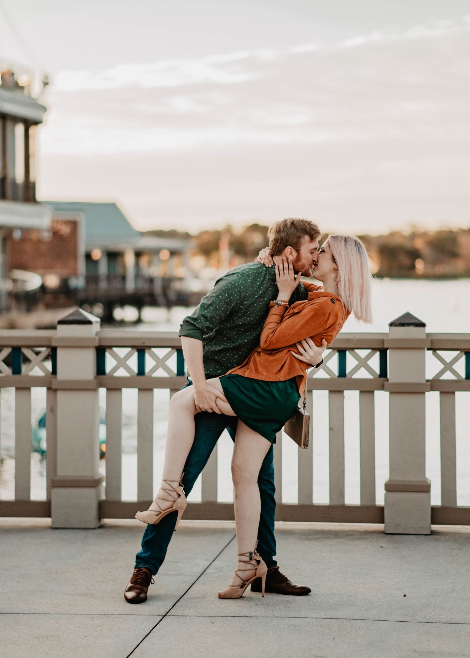 John & Emily anniversary photos at Disney Springs, dipping and kissing in front of the water. Cred: LexTakePix