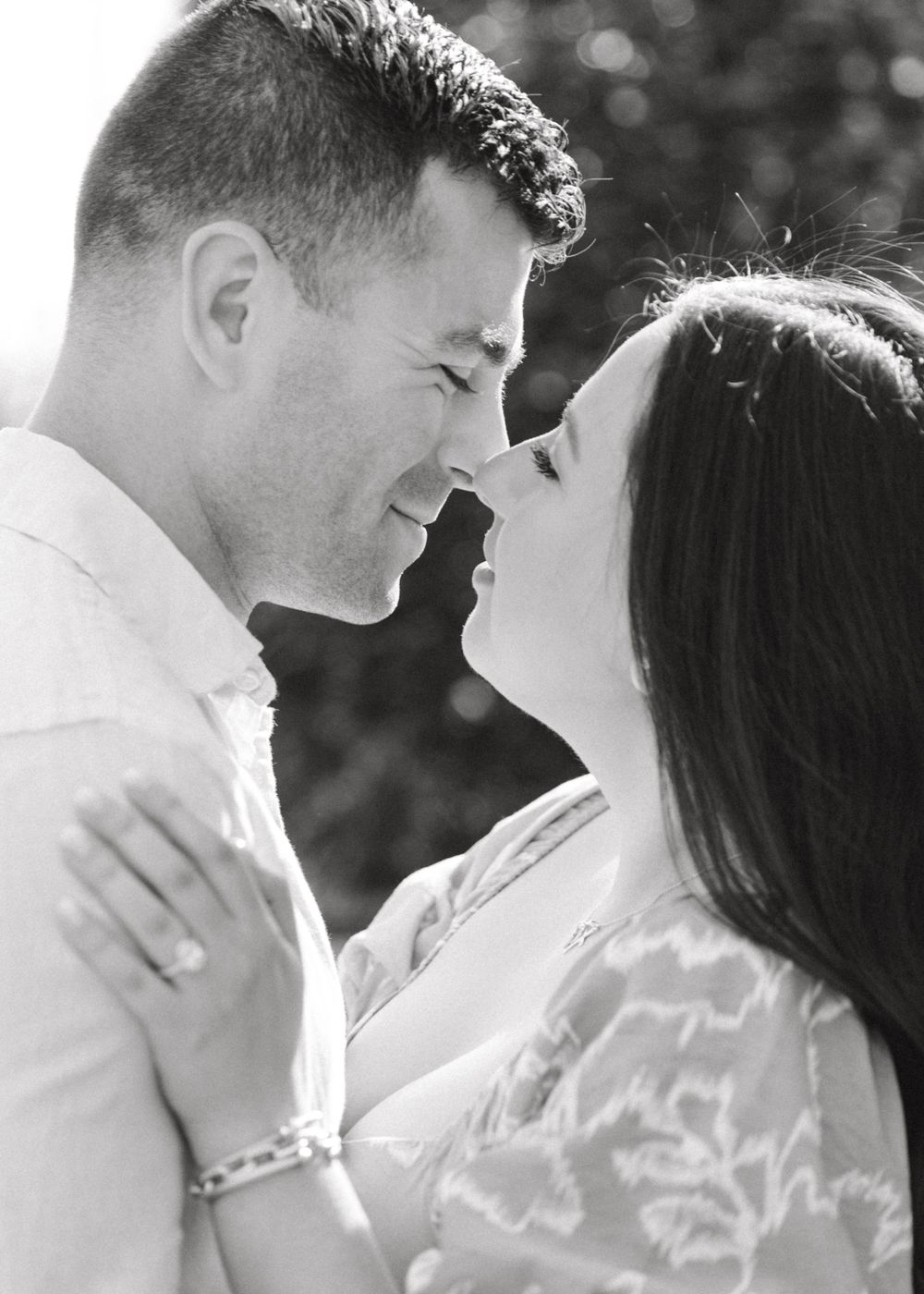Romantic engagement photo of couple in the courtyard of Jockey Hollow Bar & Kitchen in Morristown, NJ.