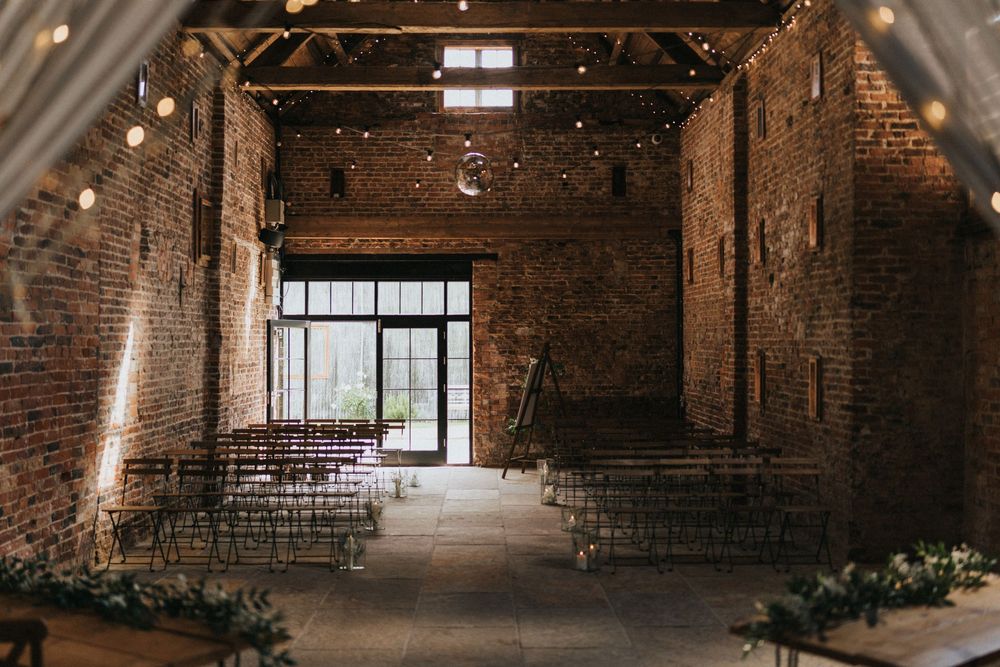 Rustic wooden beams and exposed brick walls create a charming atmosphere in this historic industrial loft event space.