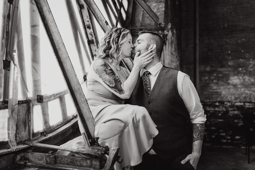 Artistic engagement photo series captures couple dancing in vintage industrial setting.