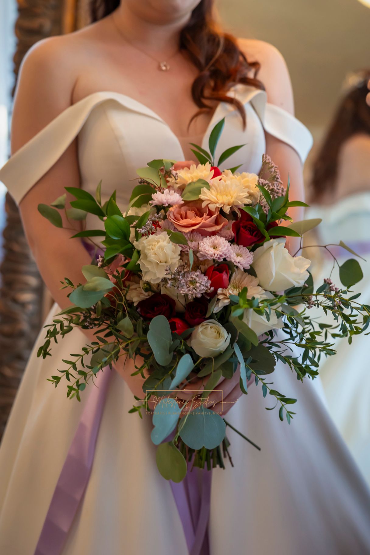 bride holding cascading bouquet