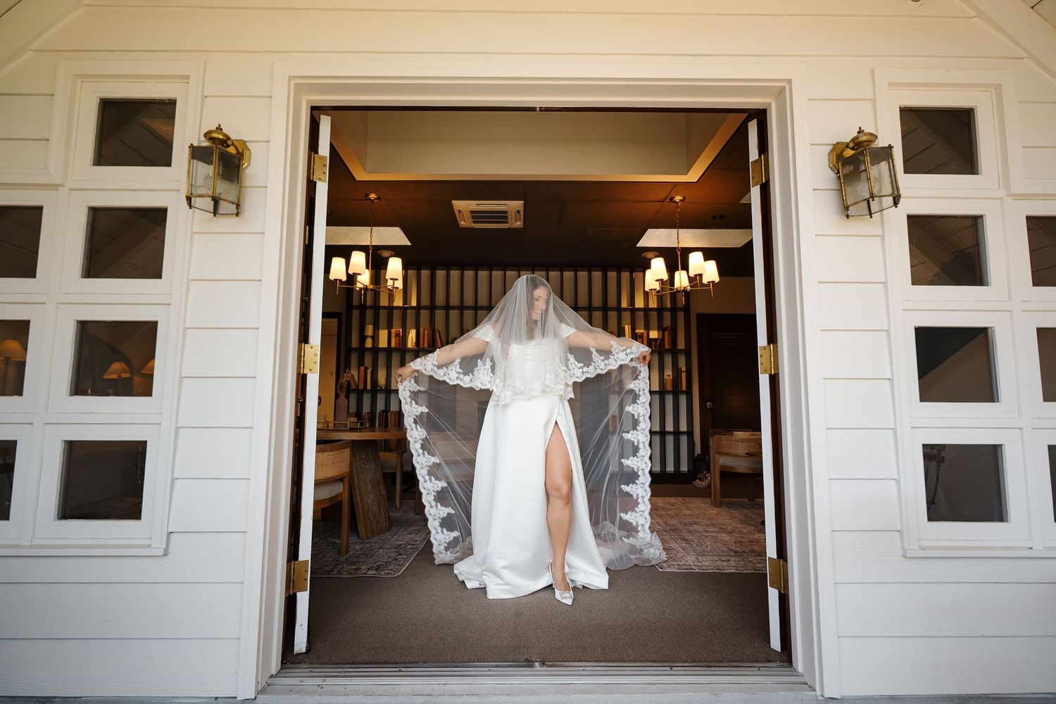 A collage of wedding dress photos displayed in a bright white barn-style venue with wooden beams and elegant lighting.