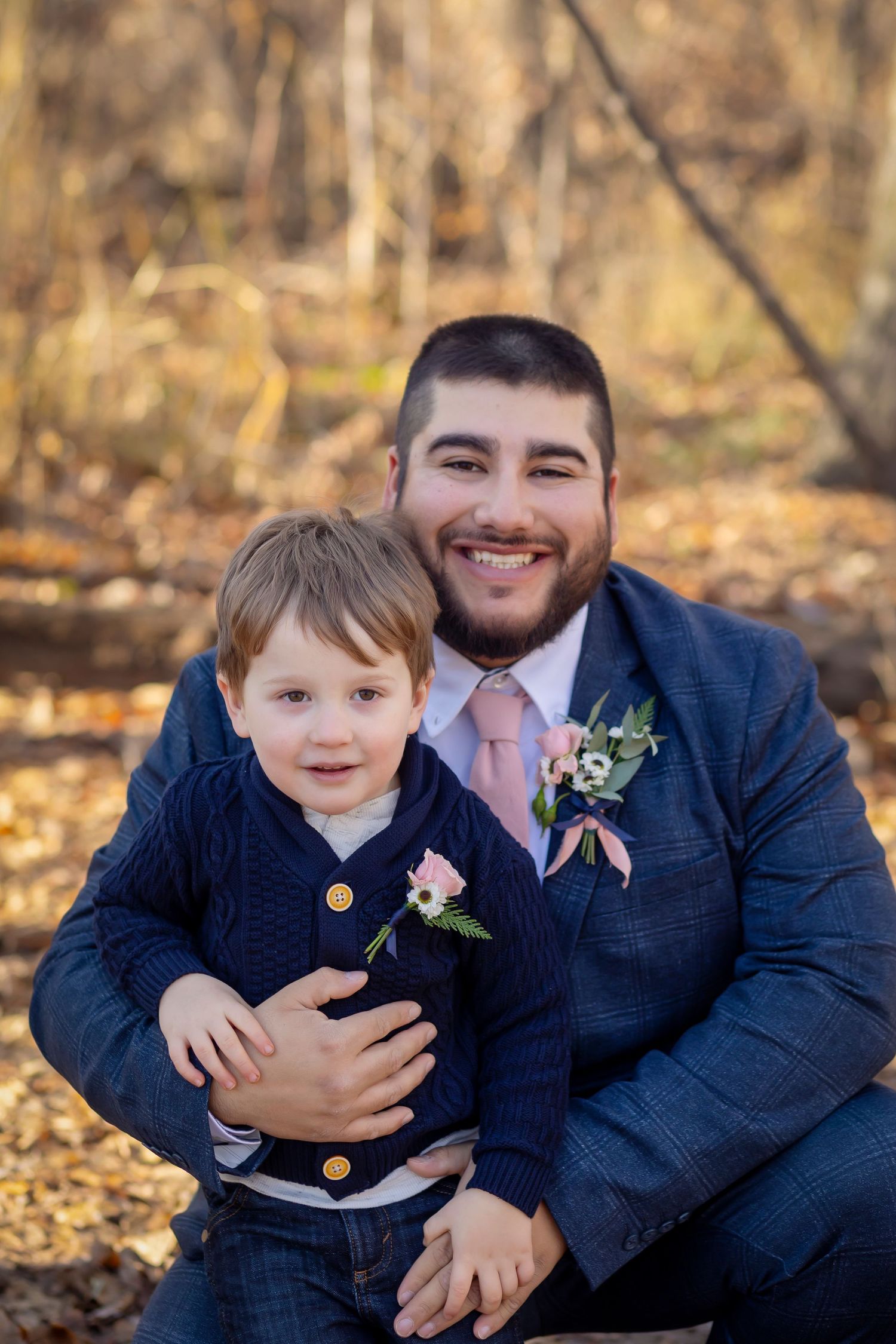 Groom and son wearing pink flower boutionners