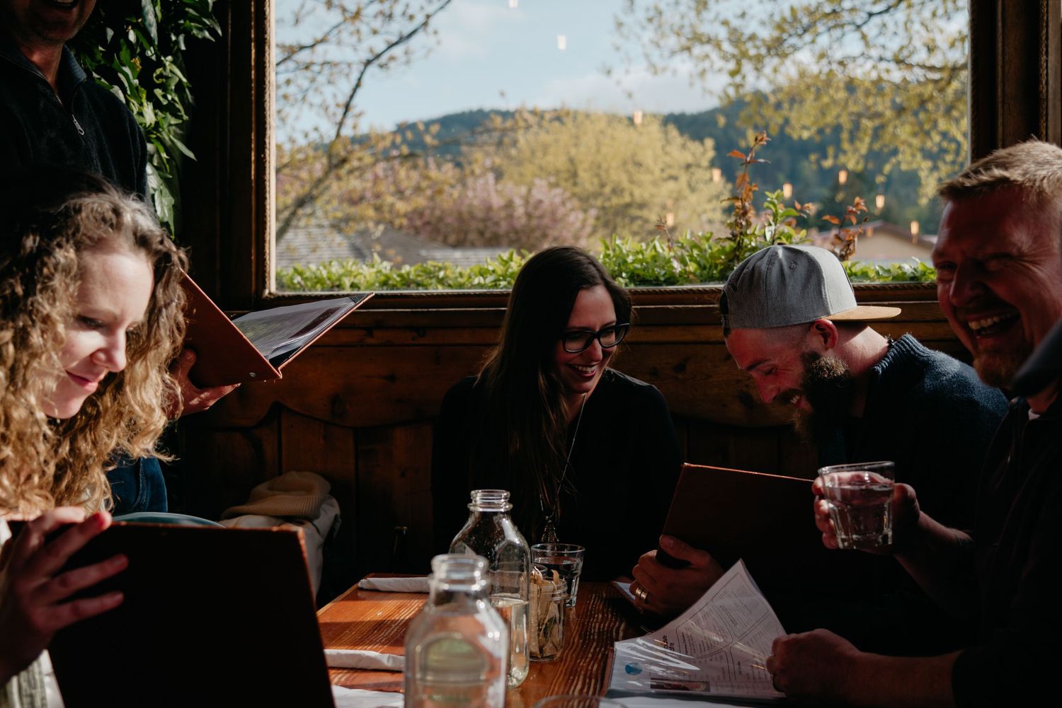Inside the treehouse cafe on Salt Spring Island people looking at menus and ordering food at the restaurant