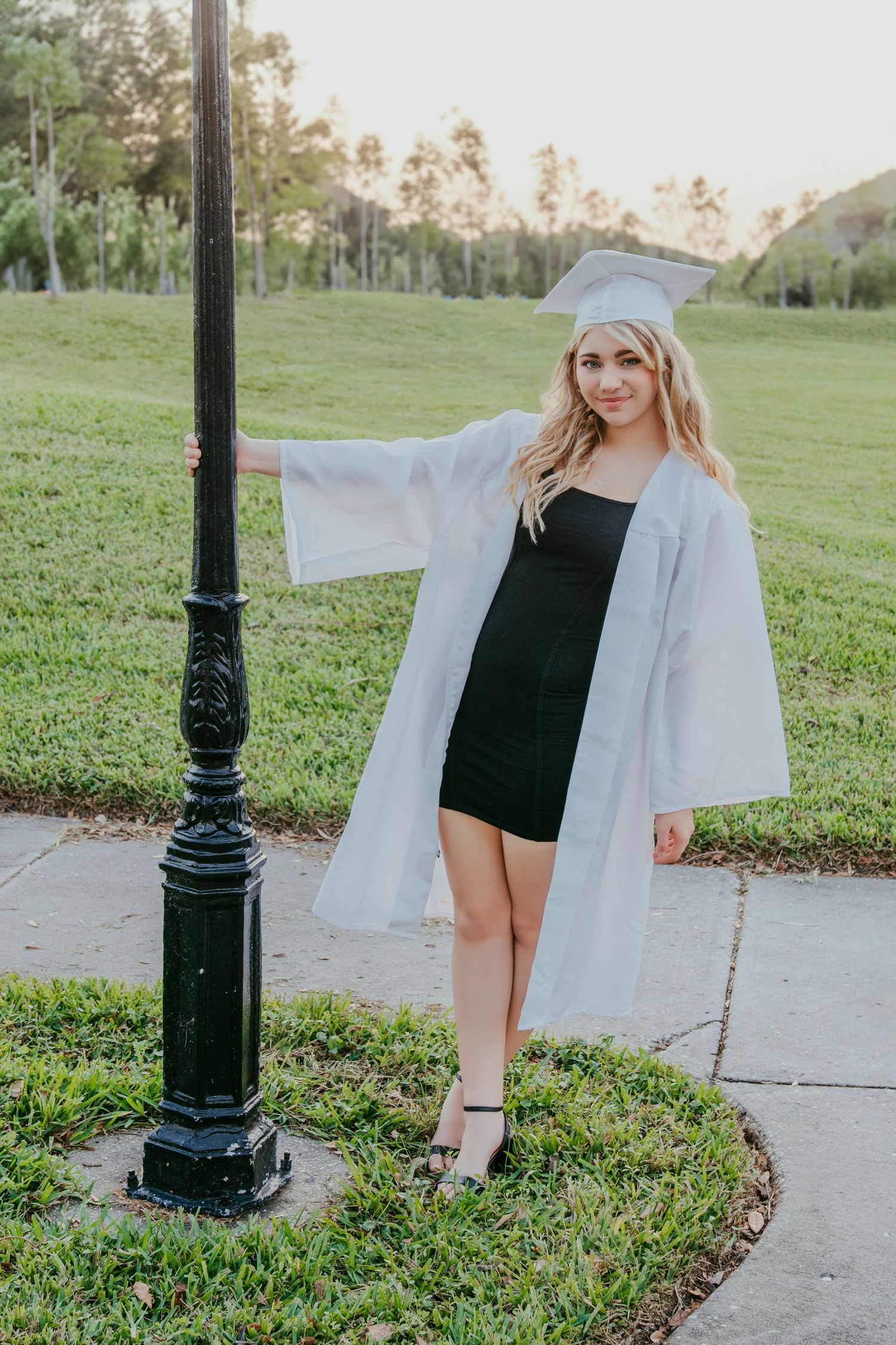 cap toss moment for senior girl at her high school stadium.