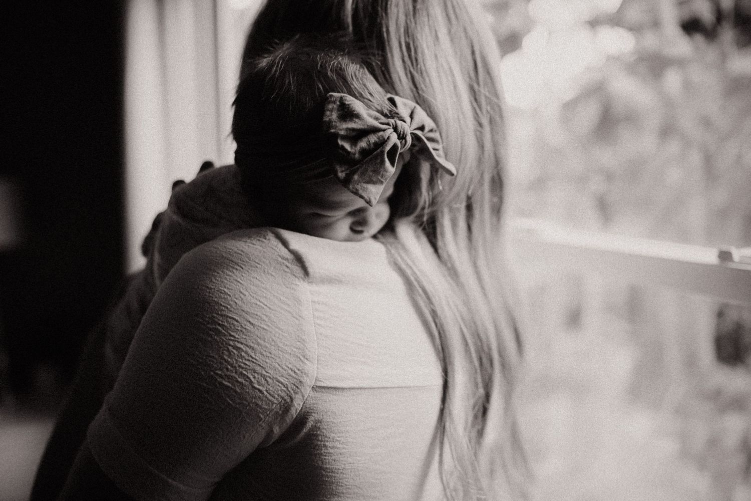 A person in white sweater embraces and comforts someone in an intimate and emotional embrace.