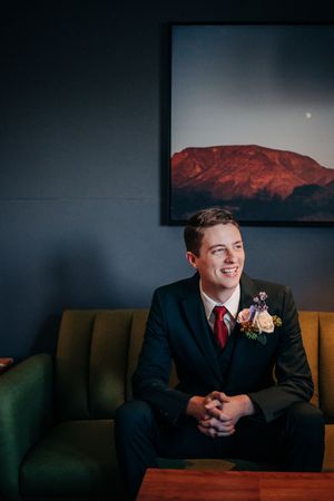 A series of atmospheric shots showing someone seated on a dark couch against a wall decorated with landscape photographs.