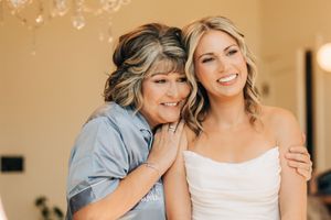 Two people share joyful embraces and sweet moments together in a series of warm-toned indoor photographs.