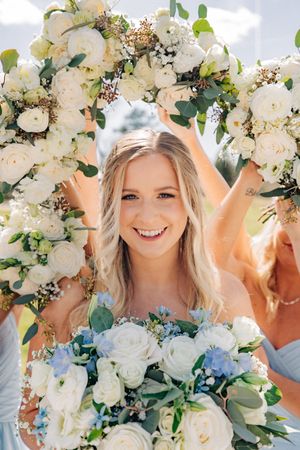 Beautiful wedding flowers with white roses and eucalyptus greenery form an elegant floral arch decoration.