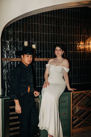Dark-clad and light-clad couple pose together in romantic nighttime shots against a patterned wall.