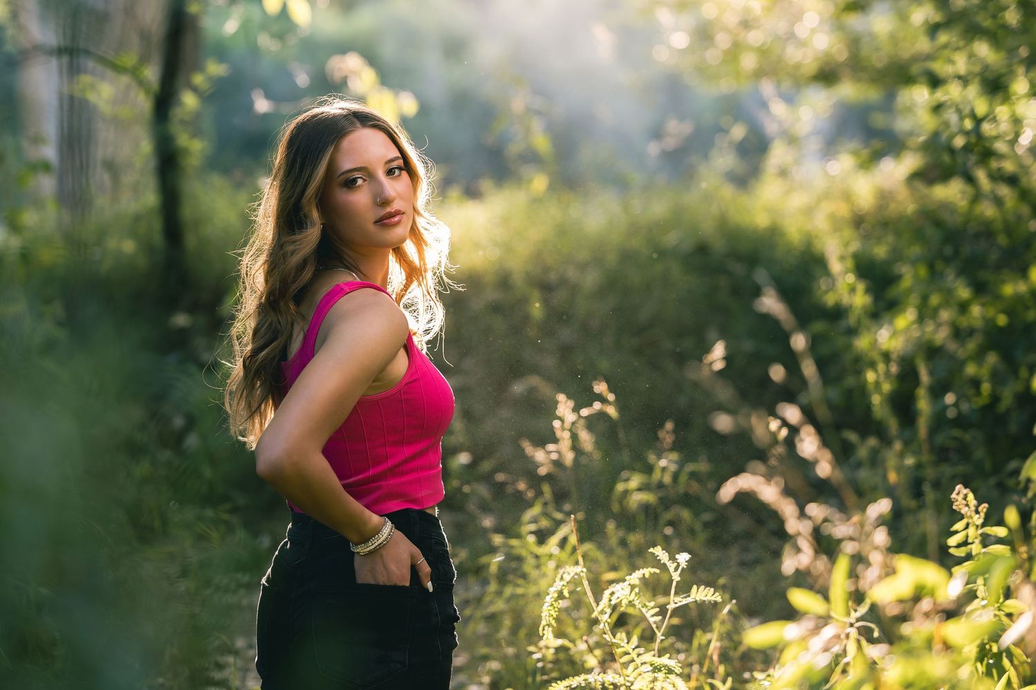 Summer portrait session in dappled sunlight with greenery.