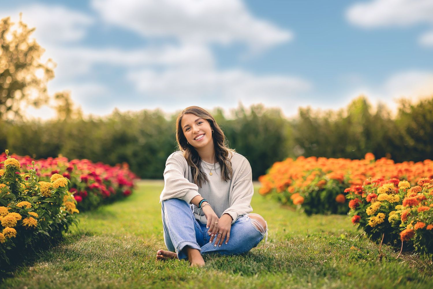 Portrait session in a vibrant flower garden with orange blooms.