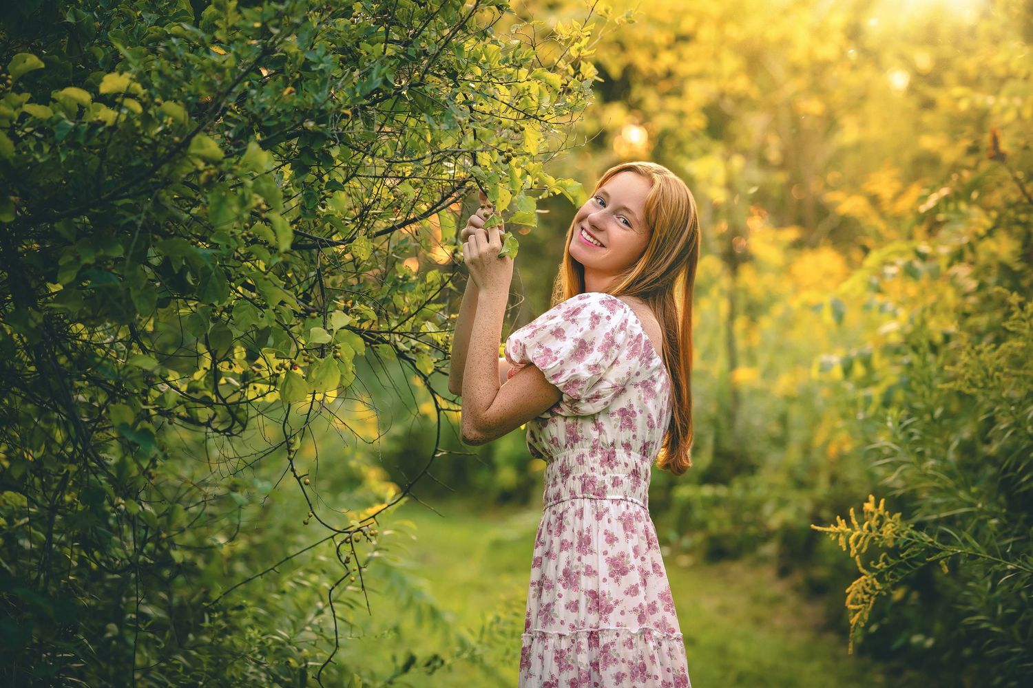 Spring garden portrait in floral dress under blooming trees with golden light.