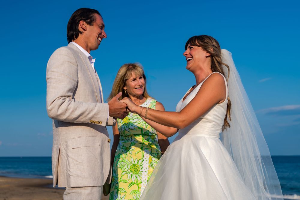 A series of romantic wedding photos showing couples embracing on a sunny beach with blue skies.