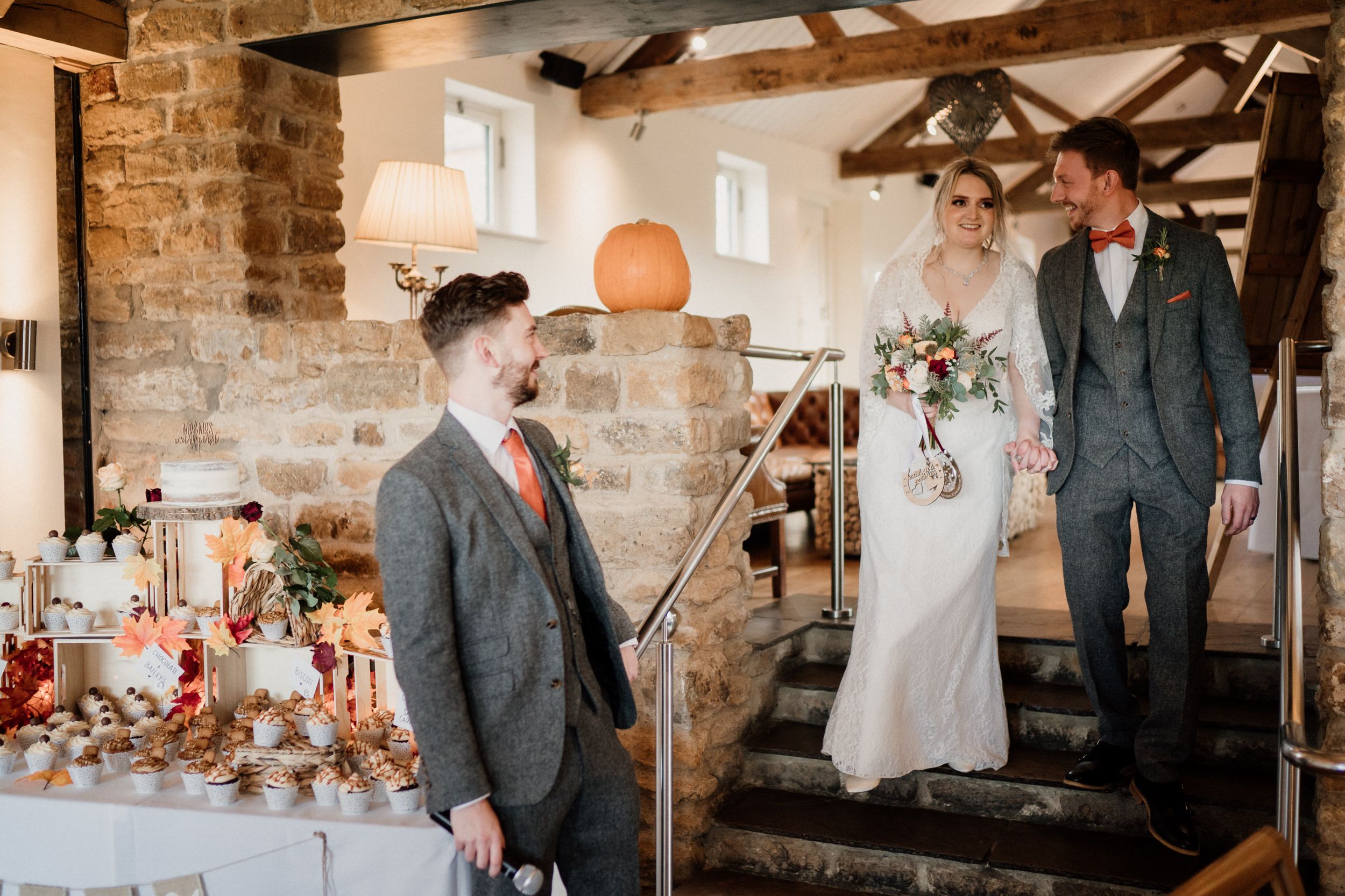 Indoor wedding ceremony space with stone walls and wooden beam architecture.