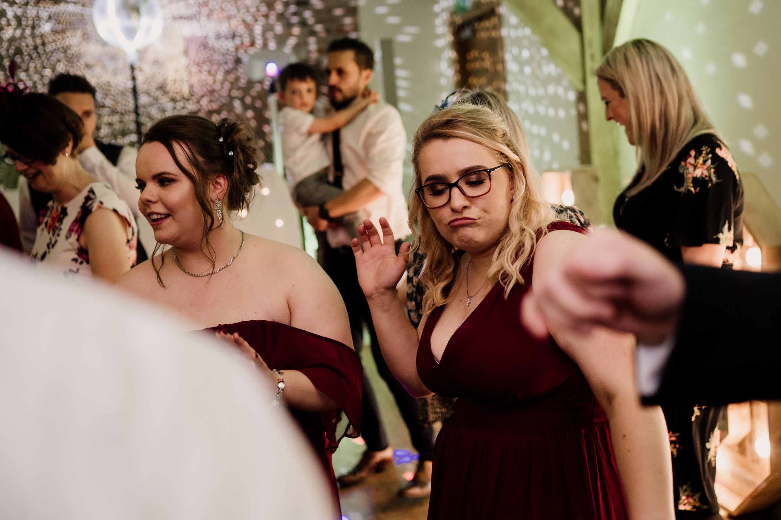 Guests in formal attire enjoy themselves during an evening wedding reception.