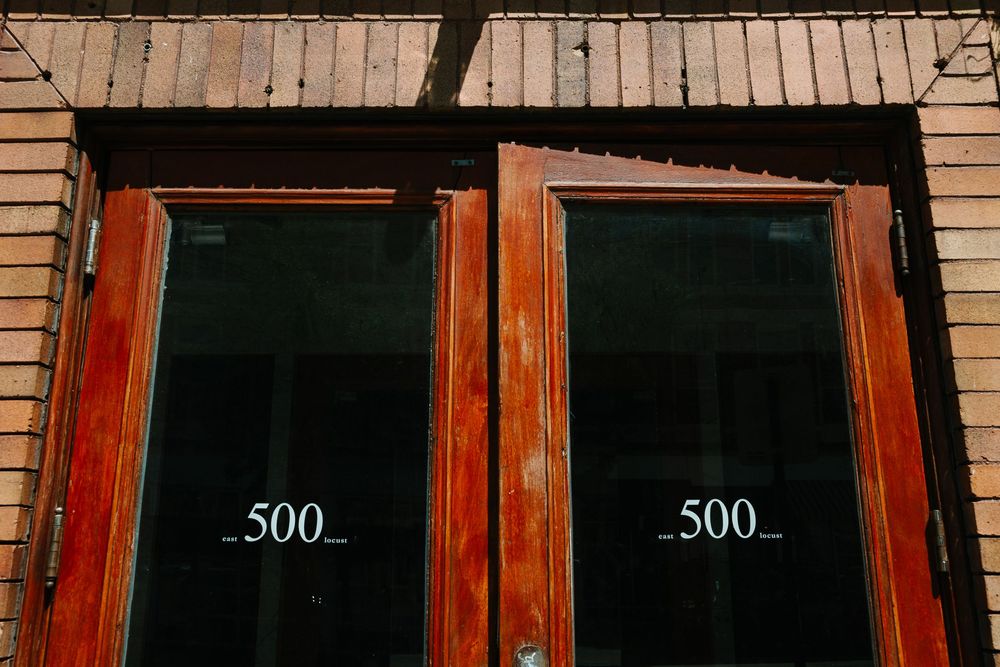 A close up of two wood doors with the number 500, outside the Teachout Building in Des Moines' East Village.