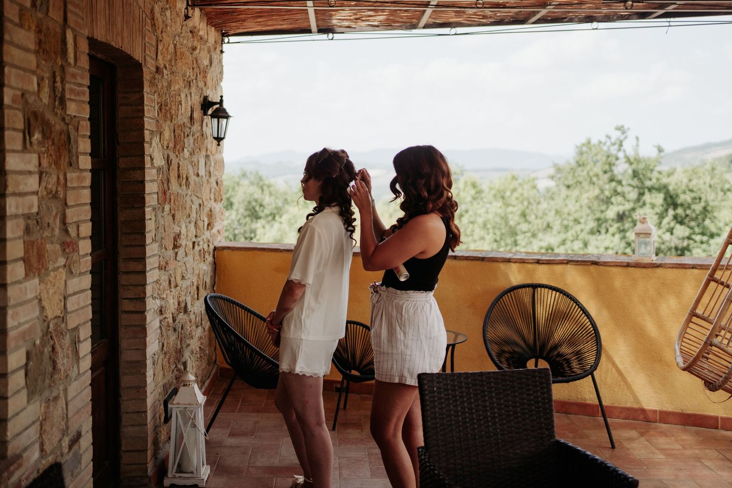 Side shot of bride and bridesmaid getting ready