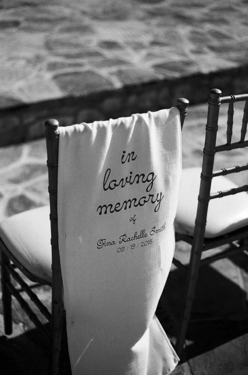 Memorial chair cover with 'In loving memory' text displayed at formal event.