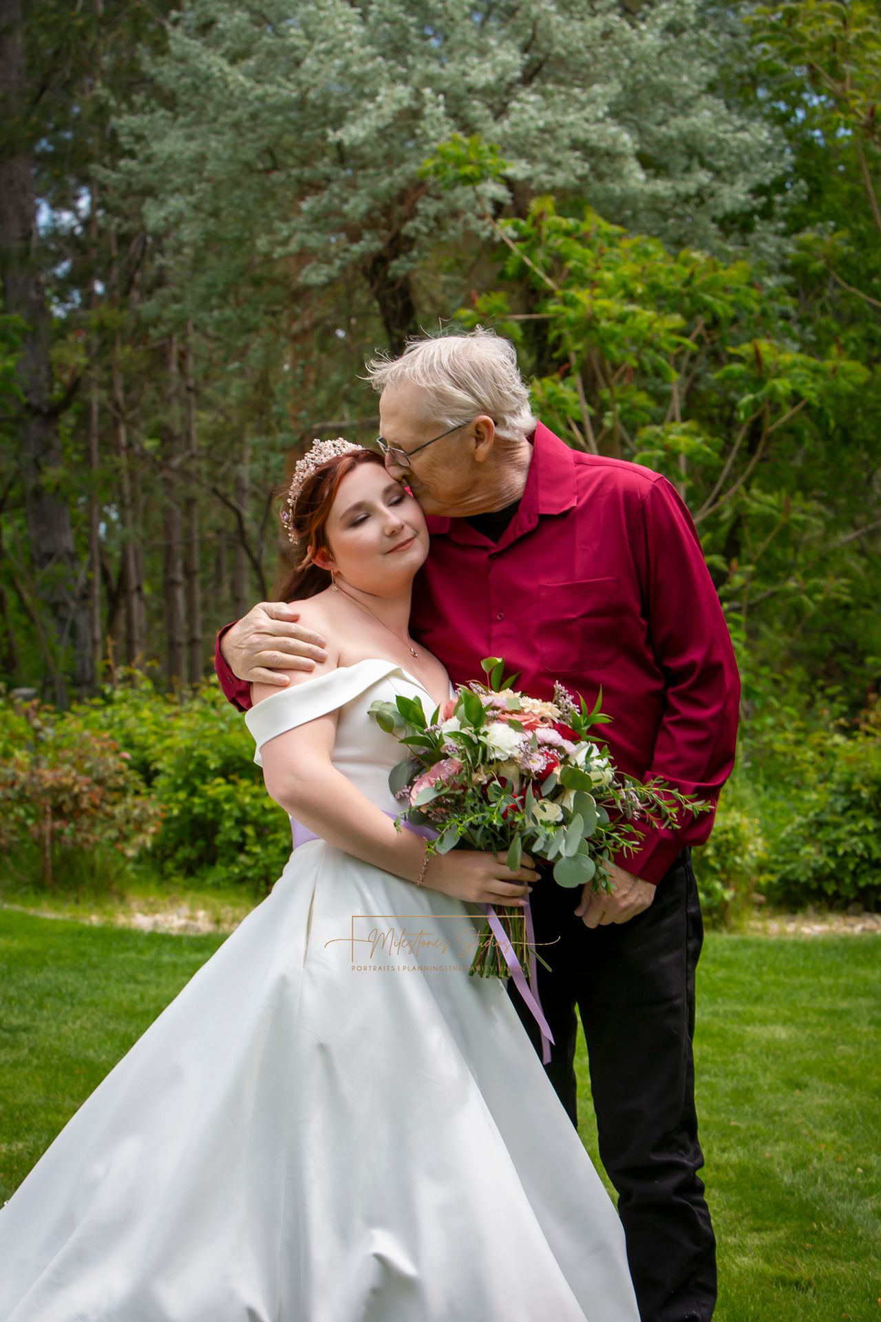 bride first look with dad-kissing her on the forehead