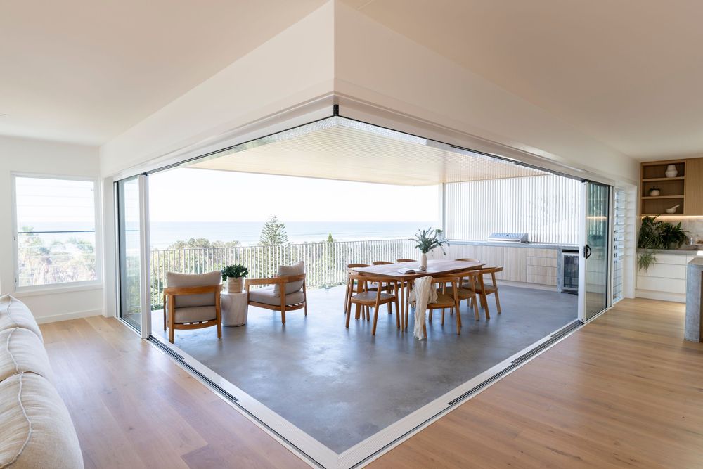 Panoramic view of a modern empty office space with floor-to-ceiling windows and light gray flooring.