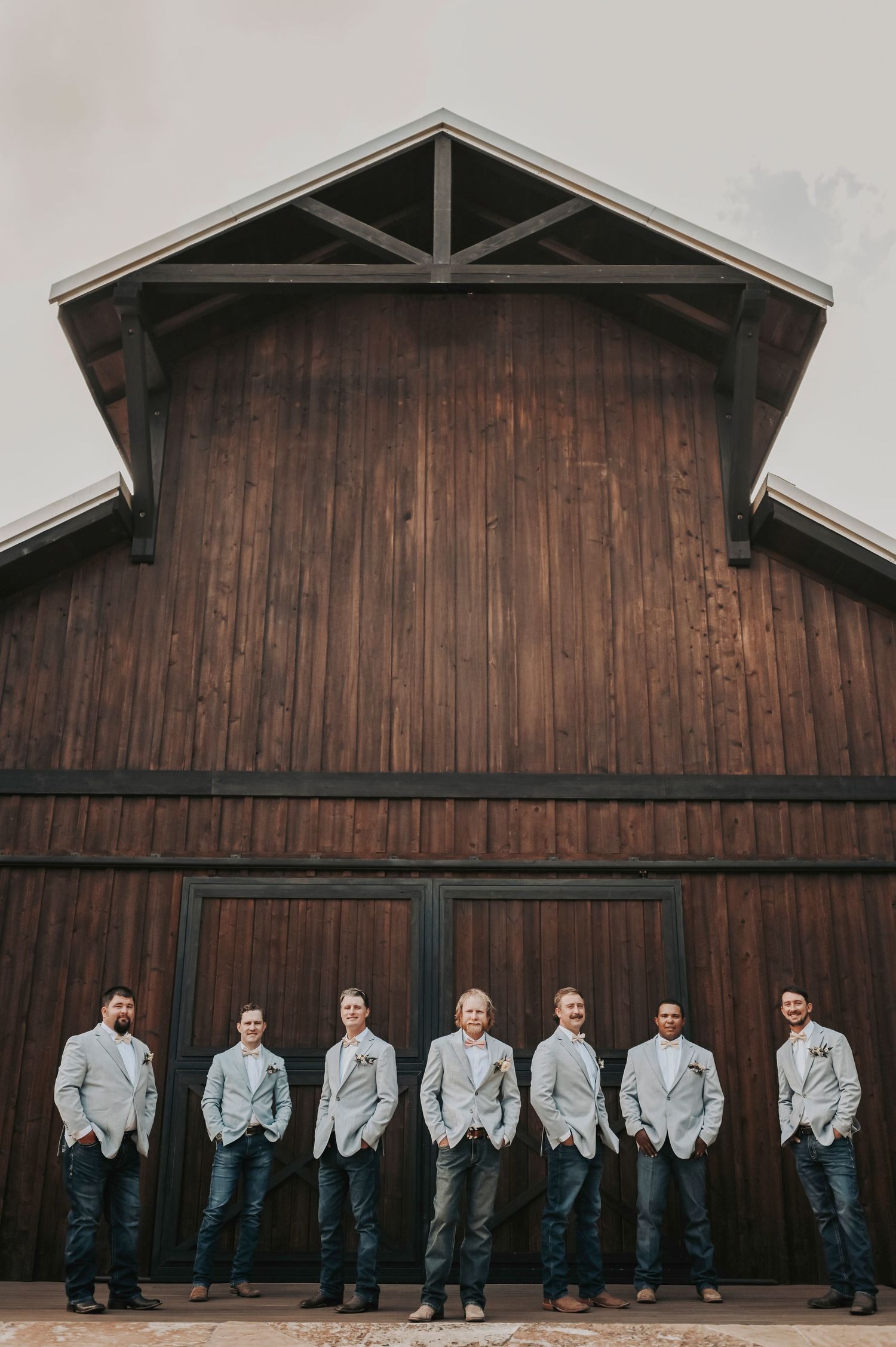 Groom and his crew with hands in pockets, looking sharp and confident