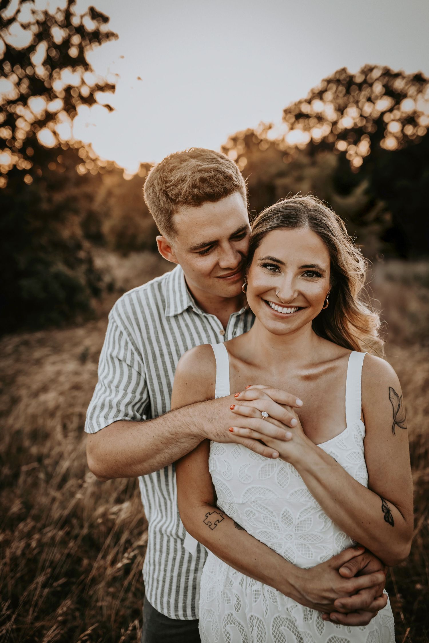 Laughing together in the middle of tall Texas grass at golden hour