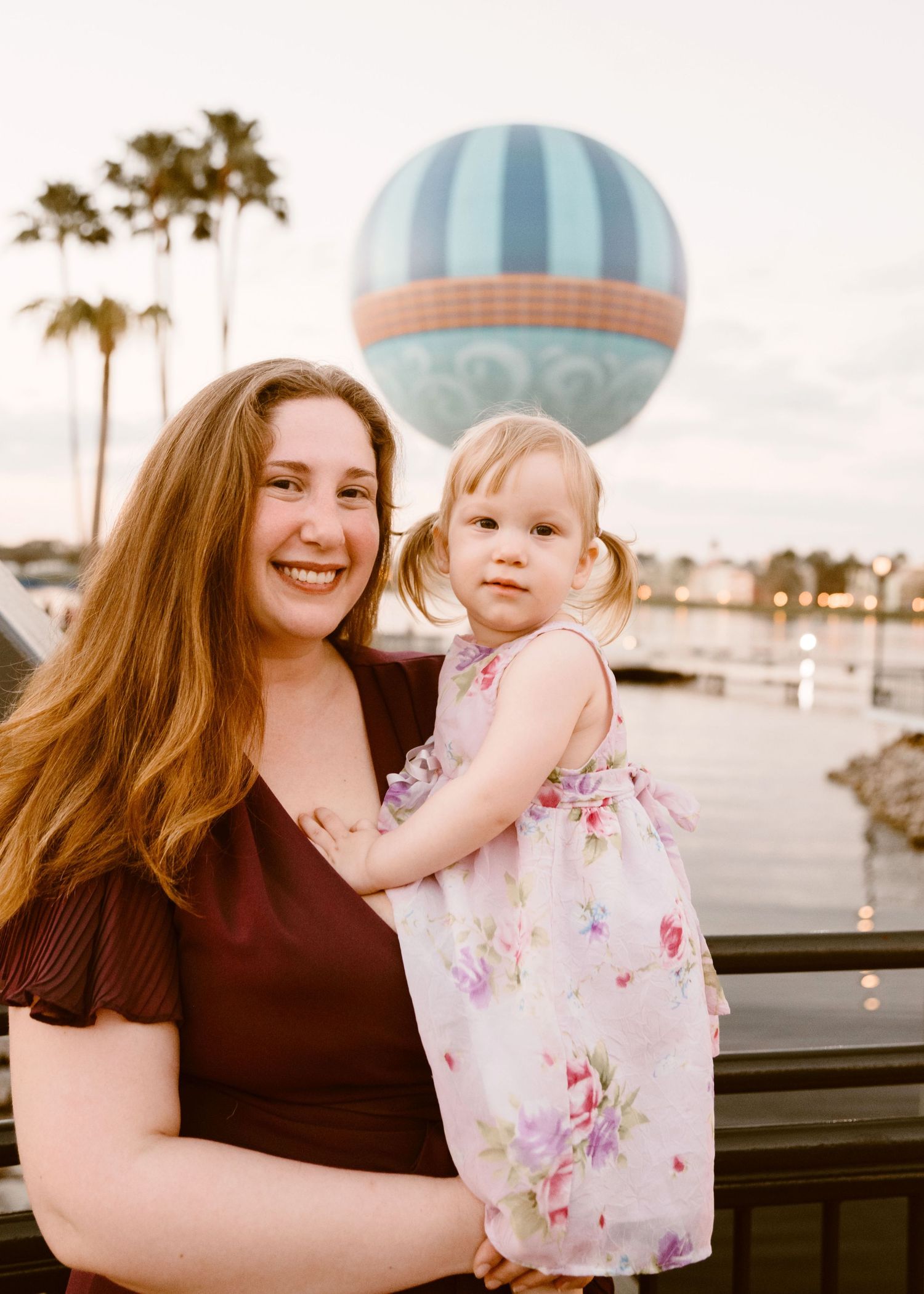John & Emily anniversary photos at Disney Springs with baby Ripley, sunset in front of Aérophile. Cred: LexTakePix