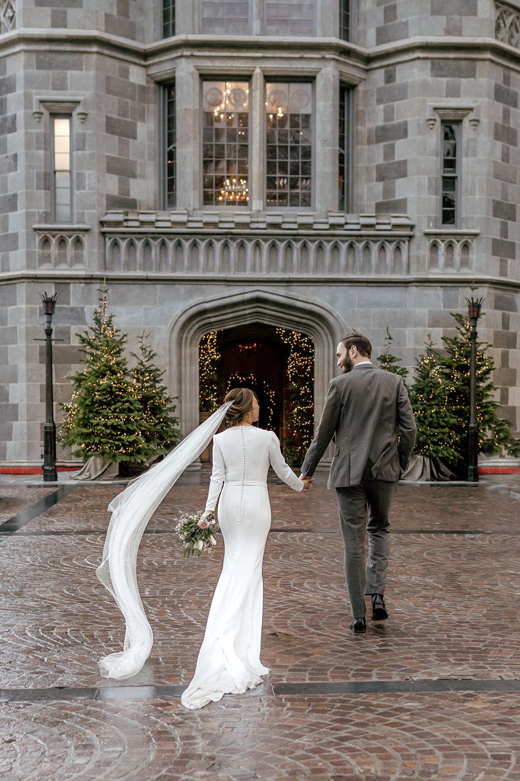 Newlywed couple stands on a green coastal cliff overlooking the ocean on their wedding day Adare Manor by Sarah Kate photography