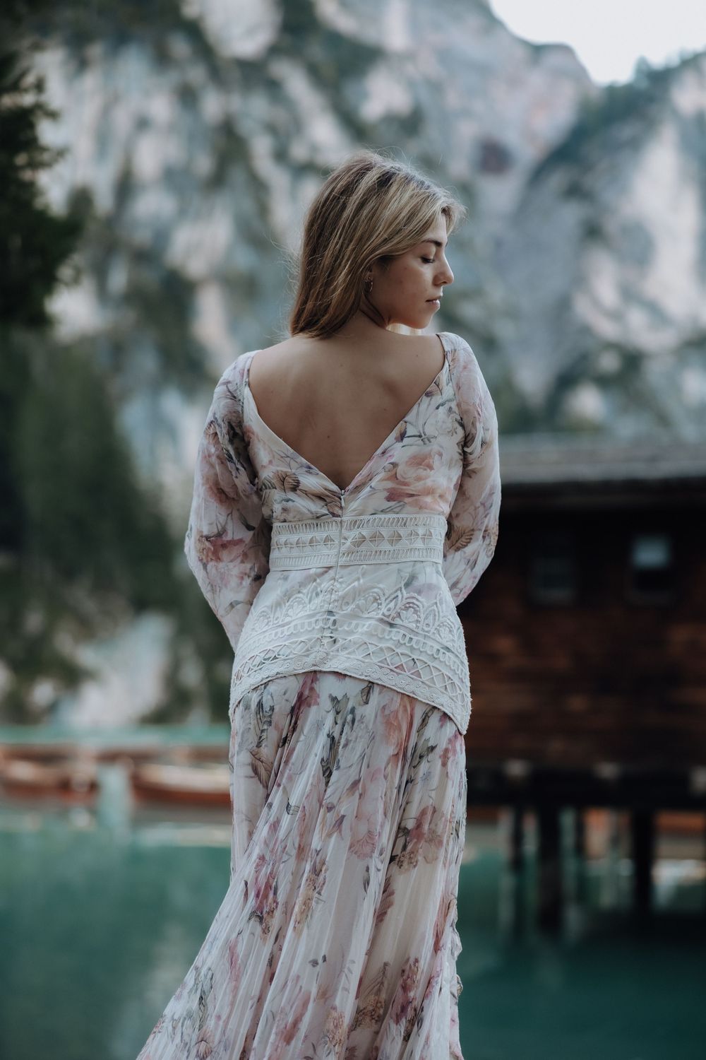 A romantic floral maxi dress with lace details shown from multiple angles in an outdoor setting at dusk.