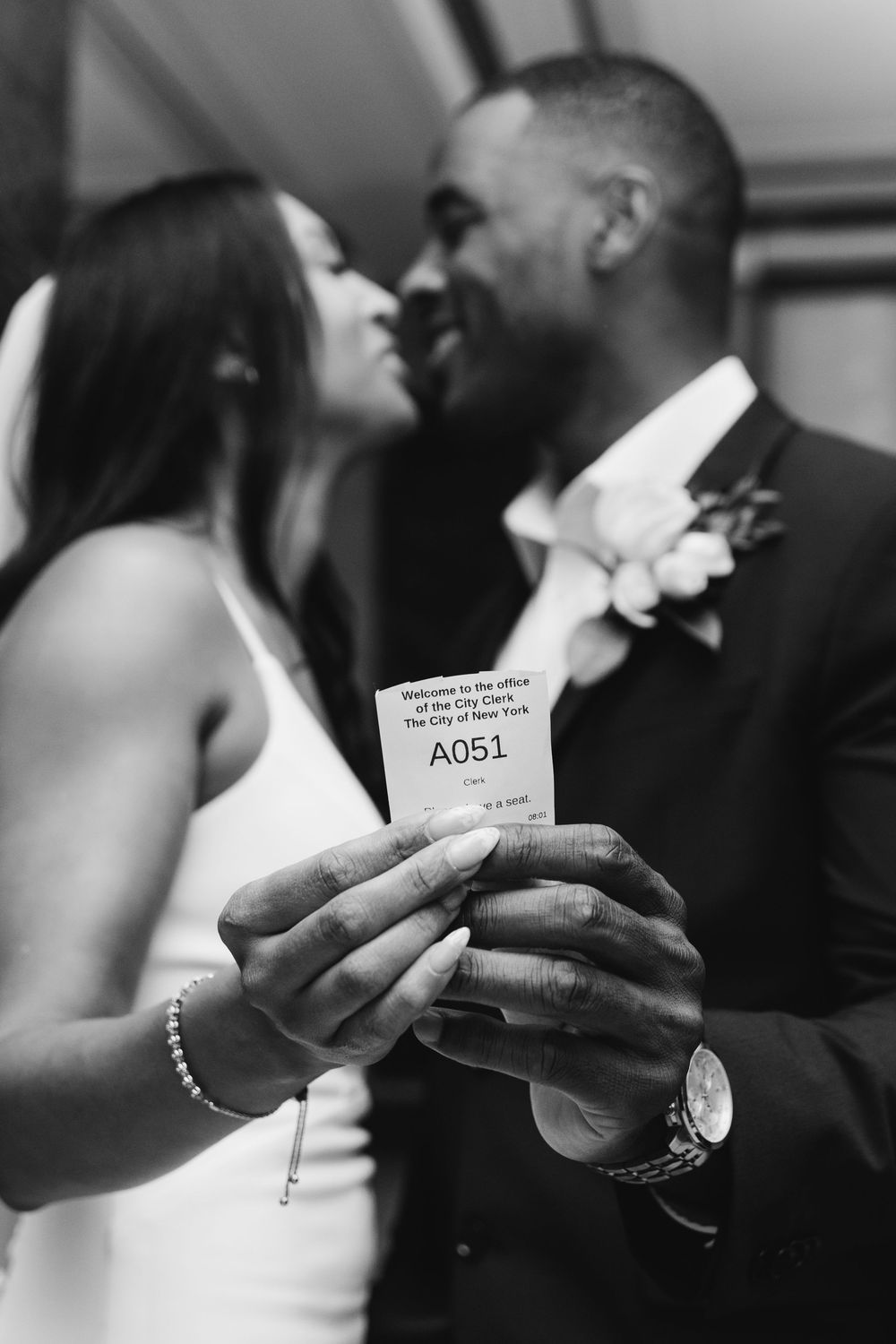 A series of black and white photos showing hands holding handwritten notes at what appears to be a wedding ceremony.