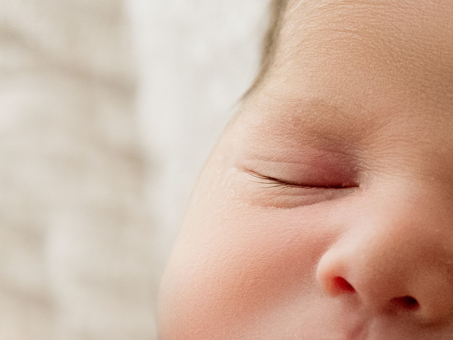 A close-up view of a baby's eyelashes shows serene contentment while sleeping peacefully.