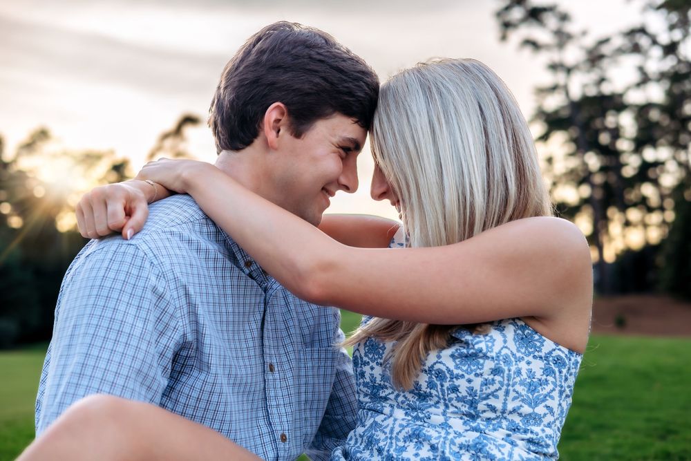 Newly engaged couple hugging after saying yes at Athens Country Club — photographed by Ansley Howe Photography