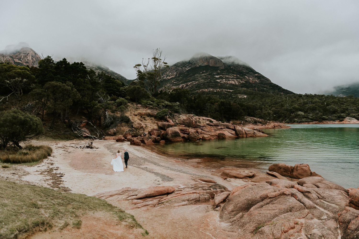 romantic image of bride and groom by tasmanian elopement and wedding photographer joss jensen taken at Richmond Bridge Tasmania