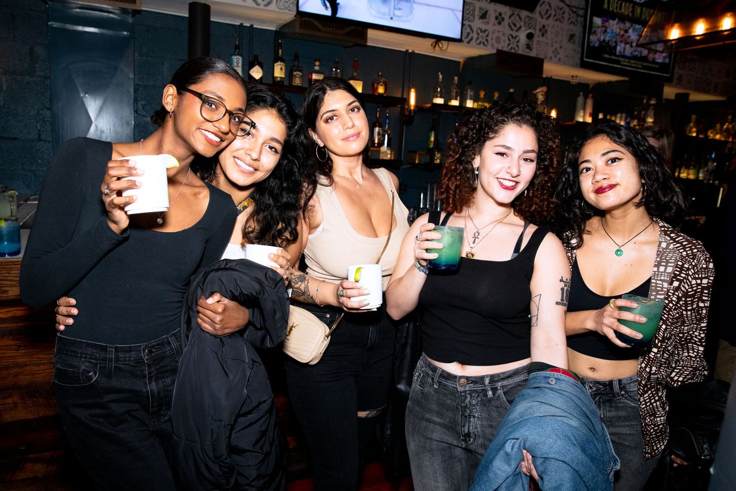Group of friends enjoying drinks and socializing at a bar.