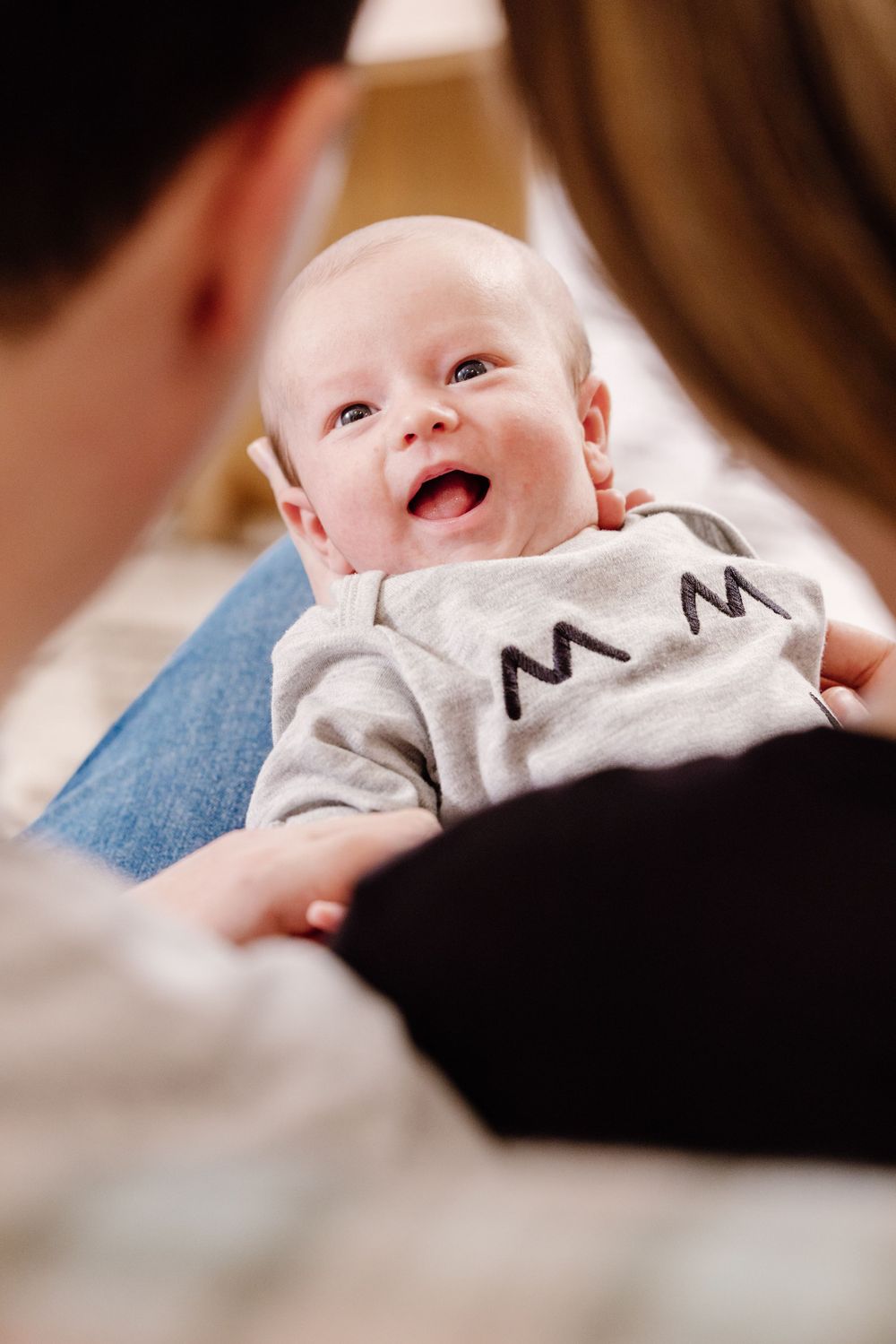 Ally, Martyn, and their newborn baby Milo enjoying a joyful moment