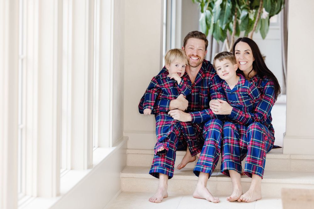 Family portrait of the Grisowld family, captured outdoors during a joyful moment together
