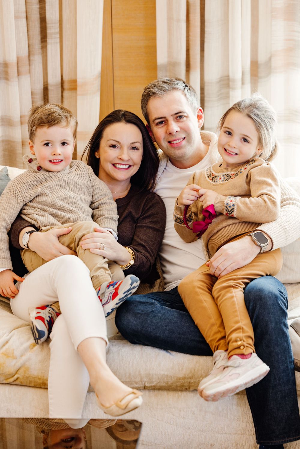 Family portrait of the Hanrahan family, captured outdoors during a joyful moment together