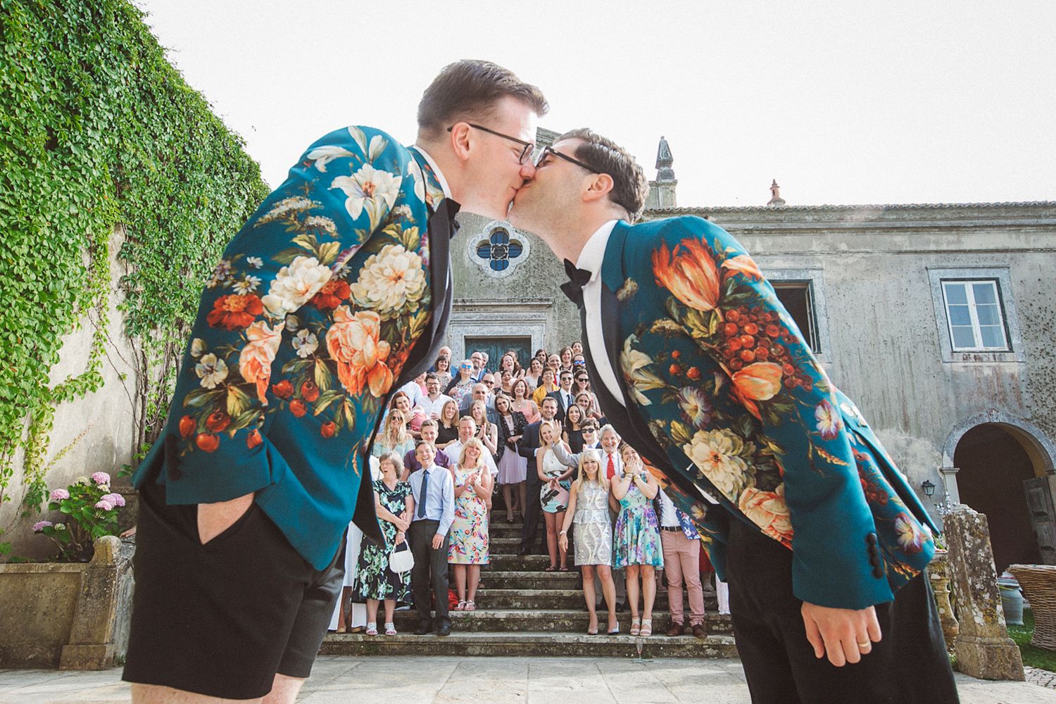 gay wedding couple kiss as guests celebrate their destination wedding in portugal. by lisbon wedding photographer