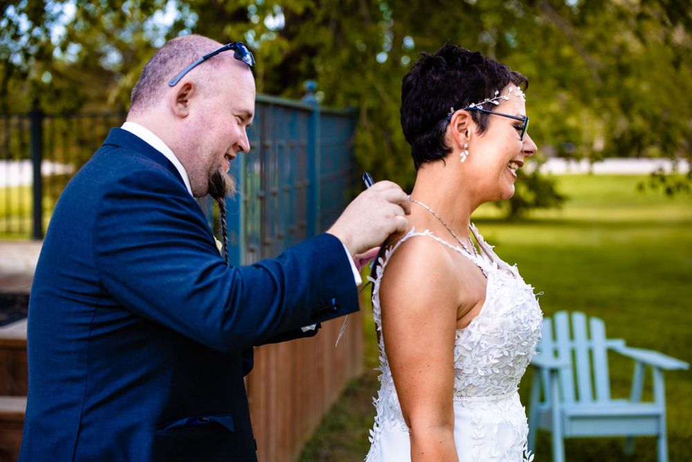 A candid wedding moment captured on a rustic porch with natural lighting and garden backdrop.