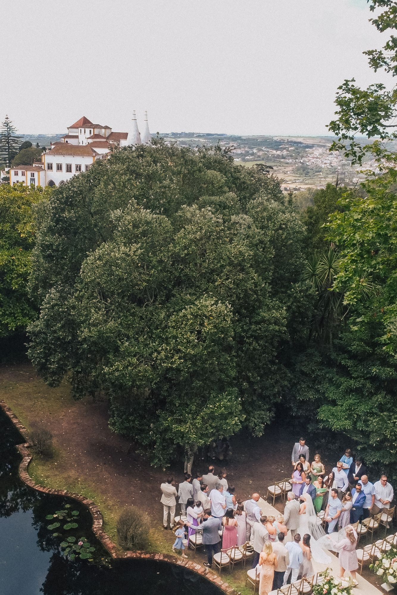 Wedding ceremony guests and newlyweds celebrate at casa dos penedos in Sintra. captured by a destination wedding photographer in Portugal