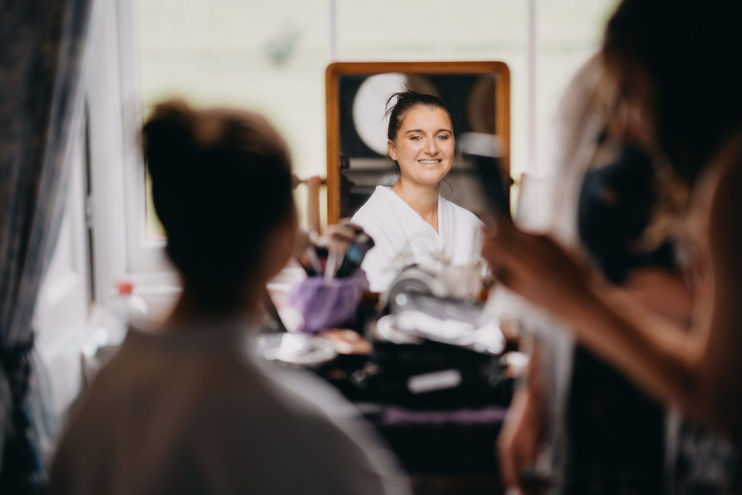 A client consultation session at a beauty salon with makeup brushes and tools on the table.