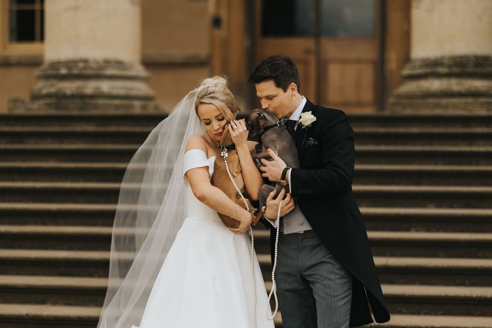 A romantic wedding photoshoot captured on grand stone steps at sunset showing intimate moments between the newlyweds.