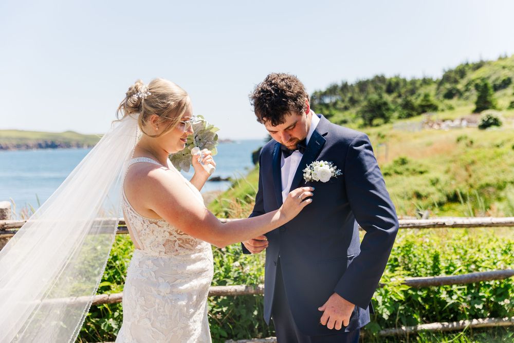 A joyful couple shares a candid moment during their coastal wedding ceremony at a scenic seaside venue.