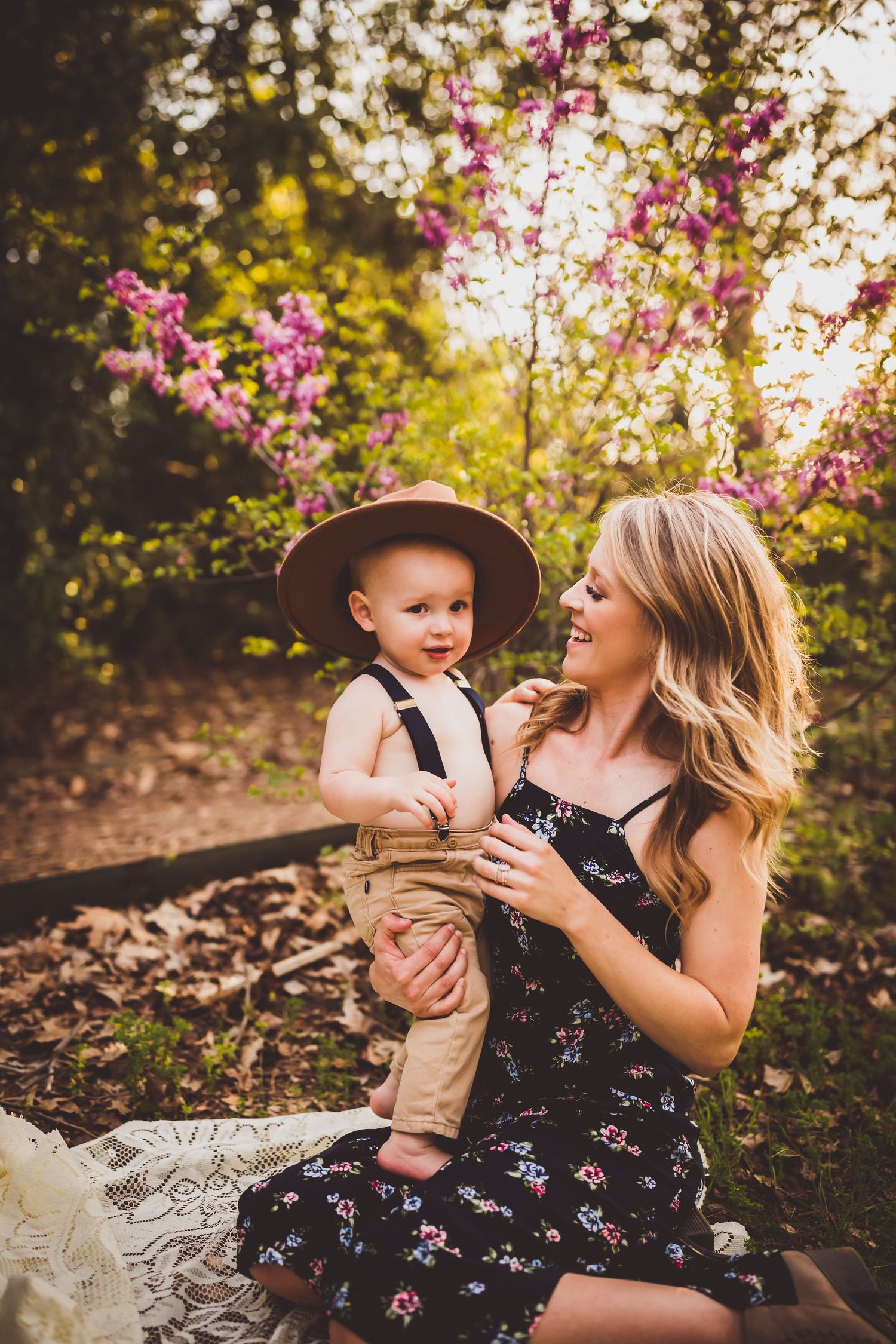 A joyful outdoor portrait session among flowering trees at golden hour.