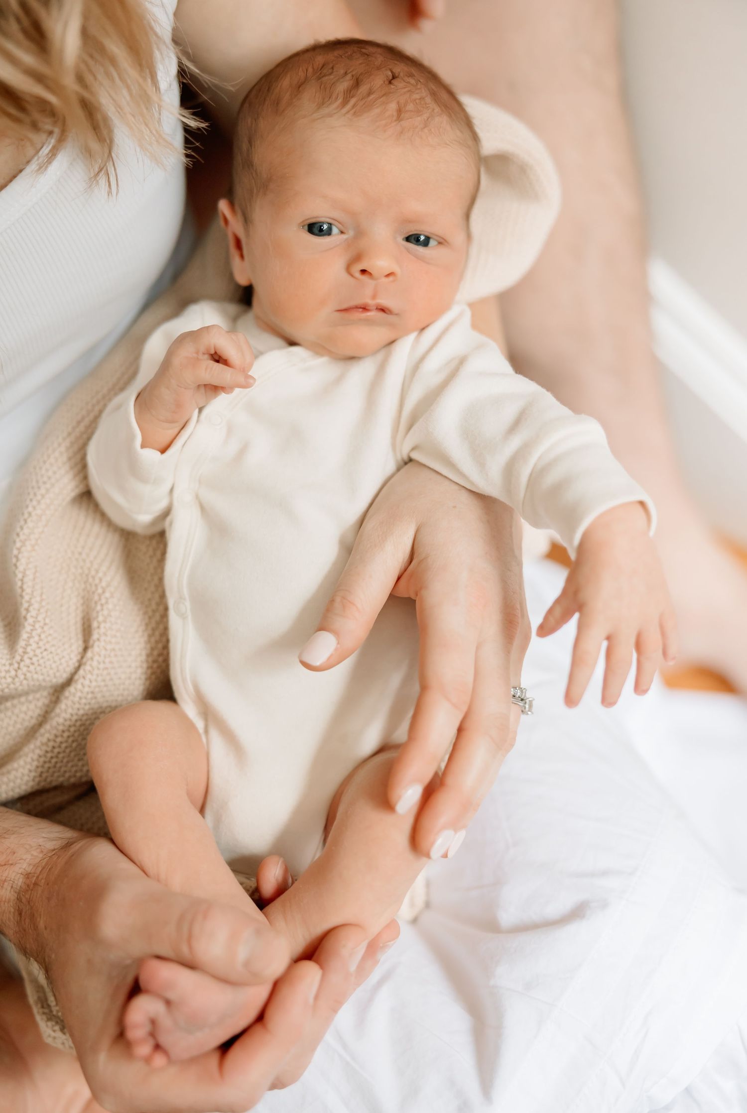 A collection of soft, dreamy newborn photography portraits in cream tones with gentle lighting and neutral backgrounds.