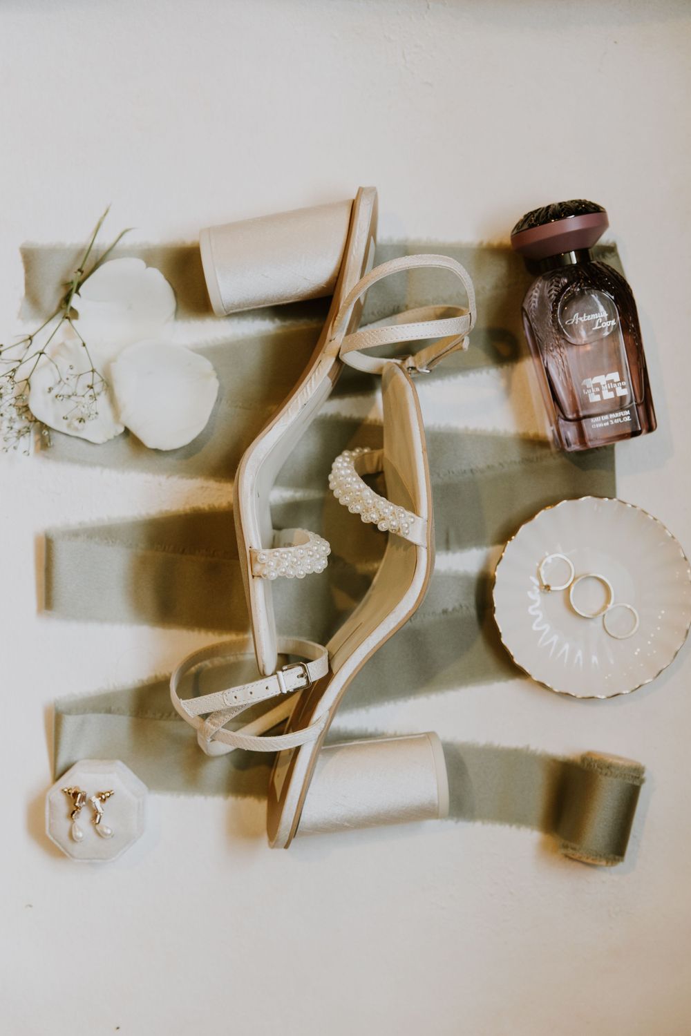 Bridal detail flat lay at wedding in Fort Pierce, Florida at The Lake House venue captured by Lindsay McDow Photography.